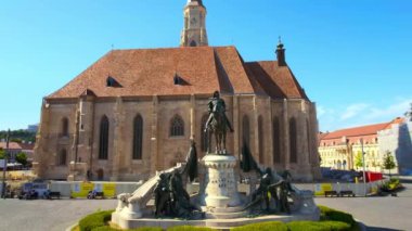CLUJ, ROMANIA - JULY, 2022: Aerial drone view of Saint Michael Church. Cityscape, central square, old buildings, people