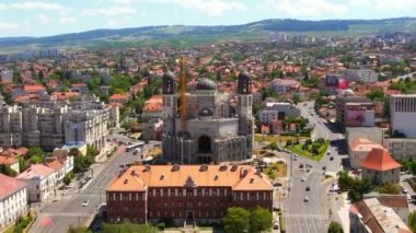 CLUJ, ROMANIA - JULY, 2022: Aerial drone view of Cathedral of Martyrs and Confessors of the XX century in the centre of Cluj Napoca, Romania. Cityscape, central square, old buildings, cars