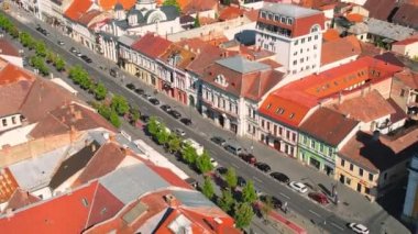 CLUJ, ROMANIA - JULY, 2022: Aerial drone view of Cluj centre, Romania. Cityscape, walking people, road with cars, old buildings