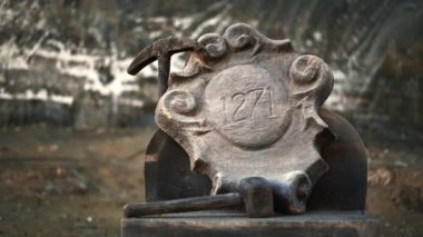 Salina Turda salt mine in Romania. Monument with a pickaxe and 1271 inscription