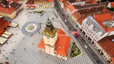 Aerial drone view of the main square in Brasov, Romania. Old city centre with museum of history, multiple buildings and people