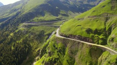 Aerial drone view of nature in Romania. Transfagarasan route in Carpathian mountains, rocky slopes with greenery