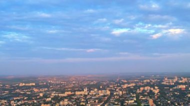 Aerial drone view of Chisinau downtown at sunset. Roads, greenery, multiple buildings. Moldova