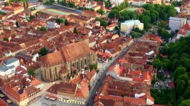 Aerial drone view of the The Black Church in old Brasov centre, Romania. Old residential buildings around it