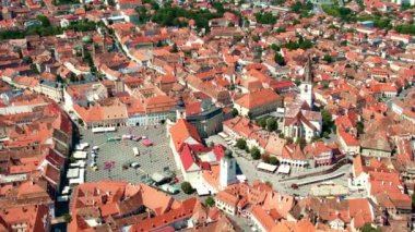 Aerial drone view of the Historic Centre of Sibiu, Romania. The Great Square with Sibiu Lutheran Cathedral and old buildings around, narrow streets