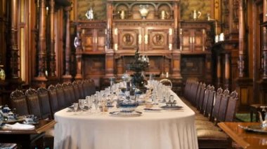 Peles Castle interior in Romania. Dining room with a set table and classic design
