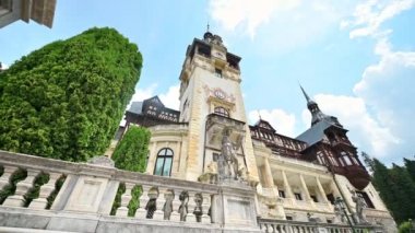 View of The Peles Castle in Romania. Castle with gardens and statues