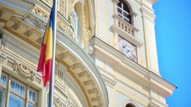 View of a building made in classic style with national flag in Sibiu, Romania