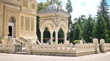 CURTEA DE ARGES, ROMANIA - JULY, 2022: Curtea de Arges Monastery. Main cathedral facade and people. Slow motion