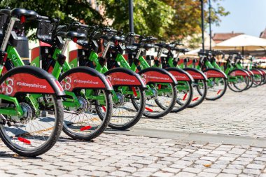 BRASOV, ROMANIA - JULY, 2022: Row of parked bicycles for sharing on a street