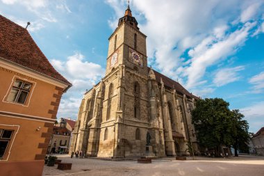 BRASOV, ROMANIA - JULY, 2022: View of the old city centre. The Black Church and people, old buildings