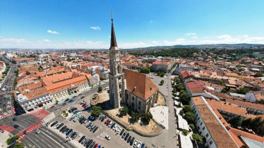Aerial drone wide view of Saint Michael Church in Cluj, Romania. Cityscape, central square, old buildings, cars