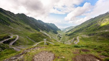 View of nature in Romania. Transfagarasan route with cars in Carpathian mountains, mountains slopes covered with greenery