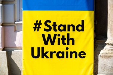Stand with Ukraine sign and flag on a street of Sibiu, Romania