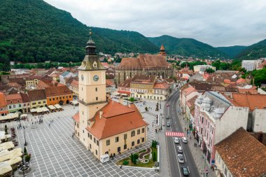 Aerial drone view of The Council Square in Brasov, Romania. Old city centre with County Museum of History, Black Church, buildings, people