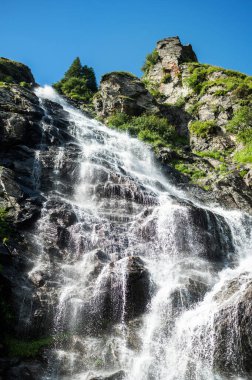 View of nature in Romania. Transfagarasan route in Carpathian mountains with near the road, rocky slopes with greenery