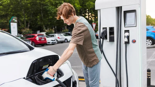 Young Man Car Charging Station Inserting Charger Electric Car Chisinau — Fotografia de Stock