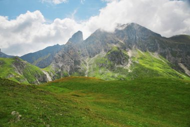 Dolomite Alps in Italy. View of mountains, valley and slopes covered with greenery