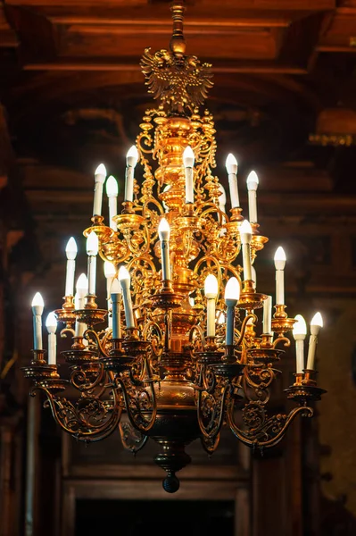 Peles Castle interior in Romania. Close view of a chandelier made in classic style