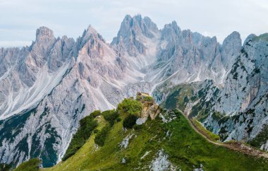 Dolomite Alps in Italy. View of mountains and green peak on the foreground