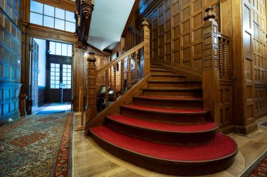 Pelisor Castle interior in Romania. Corridor with wooden stairs made classic style