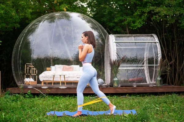 Transparent Bubble Tent Glamping Woman Doing Fitness Front Lush Forest — Stock Fotó