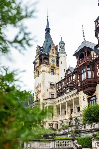 View of The Peles Castle in Romania. Castle with gardens and greenery in Carpathians