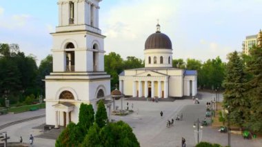CHISINAU, MOLDOVA - 2022 AĞUSTOS: Gün batımında şehrin hava aracı görüntüsü. Central Park, Katedral, çan kulesi, bir sürü yeşillik ve yürüyen insanlar.