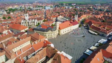 Aerial drone view of the Historic Centre of Sibiu, Romania. The Great Square with Sibiu Lutheran Cathedral and old buildings around, narrow streets