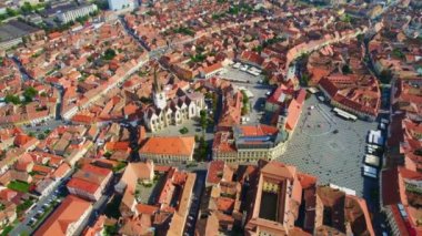 Aerial drone view of the Historic Centre of Sibiu, Romania. The Great Square with Sibiu Lutheran Cathedral and old buildings around, narrow streets