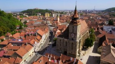 Aerial drone view of The Council Square in Brasov, Romania. Old city centre with County Museum of History, Black Church, buildings, people