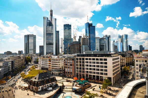 FRANKFURT, GERMANY - SEPTEMBER, 2022: Street view of the city downtown. Multiple modern buildings and skyscrapers, people