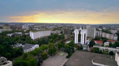 Chisinau 'nun günbatımında Moldova' da hava aracı görüntüsü. Başkanlığı ve parlamentosu olan şehir merkezi manzarası, birden fazla bina, yollar, yemyeşil