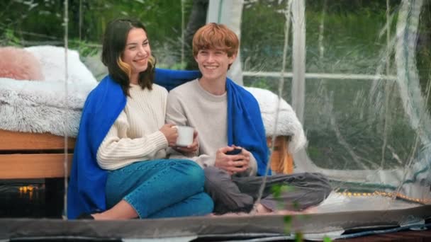 Couple Sitting Transparent Bubble Tent Glamping Sitting Blanket Holding Cups — Stock Video