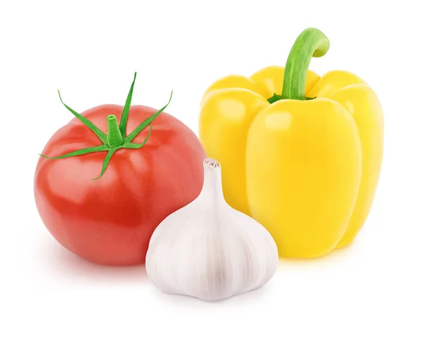 Plantaardige samenstelling: tomaat, knoflook en paprika op een witte achtergrond. Stockfoto
