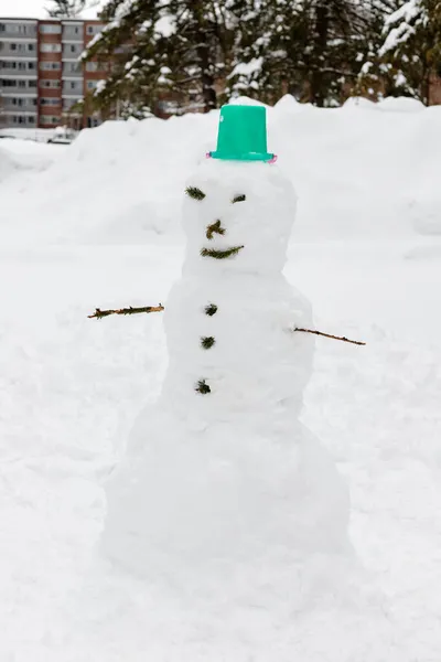 雪の寒い冬の日に家の近くの庭で雪だるま 子供や家族のための楽しい屋外活動 — ストック写真