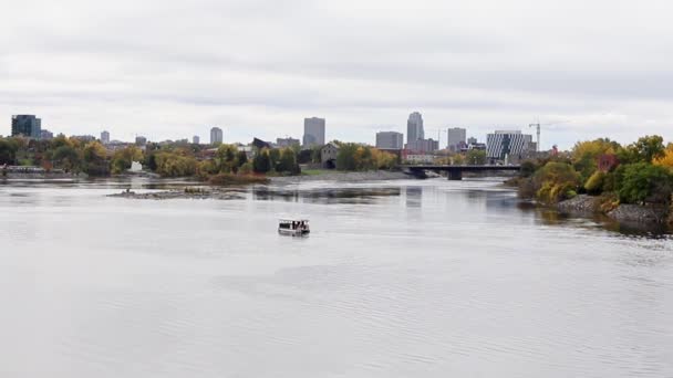 Portage Bridge between Ottawa, Ontario and Gatineau, Quebec in Canada. River with boat and cityscape in fall — Stock Video