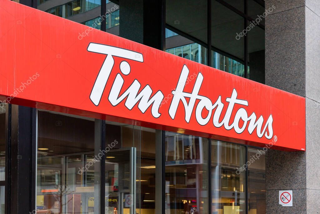Ottawa, Canada - December 16, 2021: Signage of Tim Hortons restaurant in downtown of Ottawa, Canada. Tim Hortons is a popular canadian fast food restaurant.
