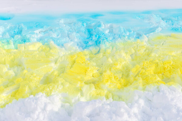 Ukrainian blue and yellow flag painted on snow with spray paint