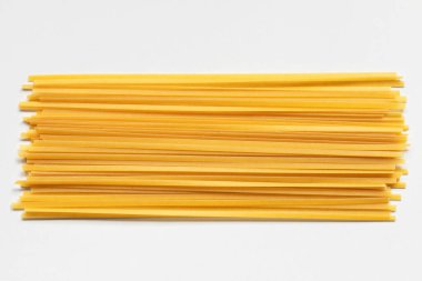 Durum fettuccine pasta on white background. Raw spaghetti or noodles clipart