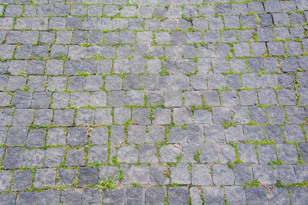 Background road from blocks. Wallpaper road large stones.