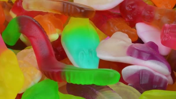 Candy sweets background. Assorted colorful mixed candies. Colorful delicious sweets turning top view. Rotating. View from above. Extreme close-up — Stock Video