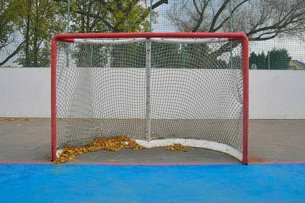 Abandoned hockey goal in fall. Concept of finished field hockey season — Stock Photo, Image