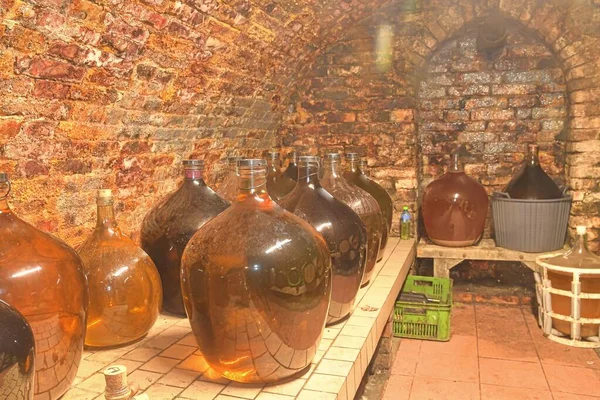 Vintage demijohns egy hagyományos borospincében. Demijohn borosüvegek — Stock Fotó