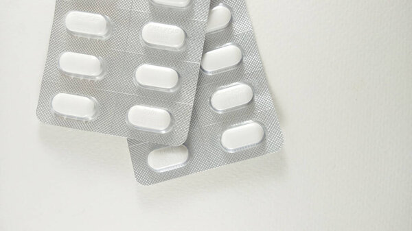 2 packs of calcium tablets on white, placed on a white background. V3