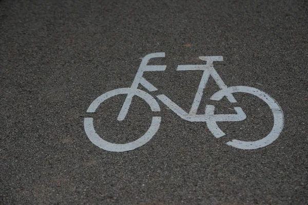Bicycle path logo symbol on gray asphalt. close-up