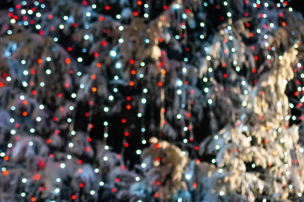 Snowy Christmas Tree Decorated Lights Night Blurred Bokeh — Fotografia de Stock