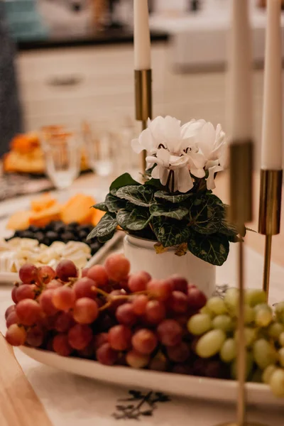 Festive Table Burning Candles Gold Candlestick Red Green Grapes White — Stock Photo, Image