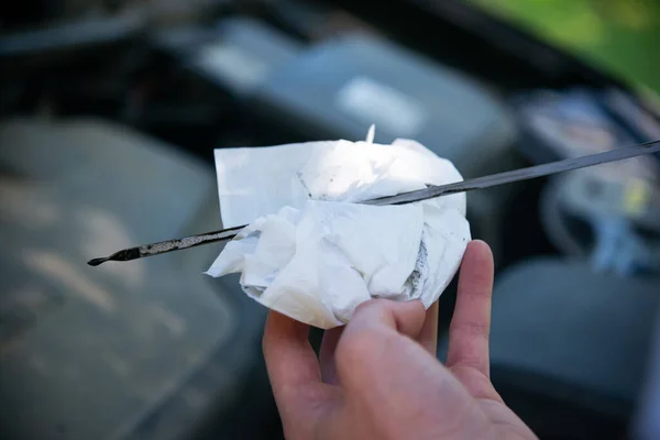 Hands of technicians Check Car Engine Oil , selective focus