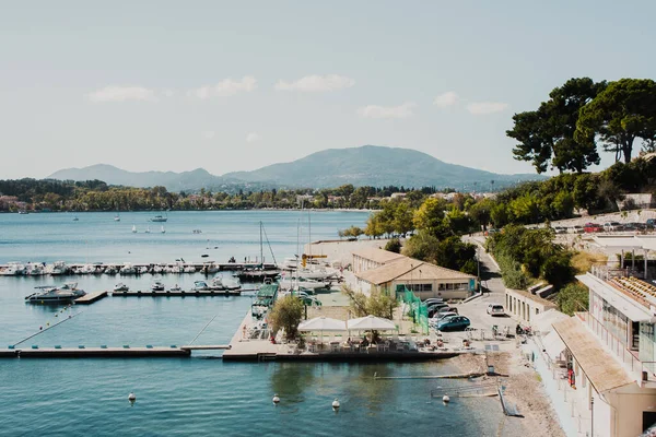 Lake shore with houses in Greece. Boat docks in the lake.